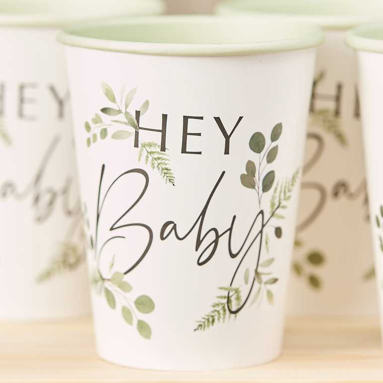 botanical greenery leaf style paper party cups with the words 'hey baby' printed on them for a botanical gender neautral baby shower party theme decoration