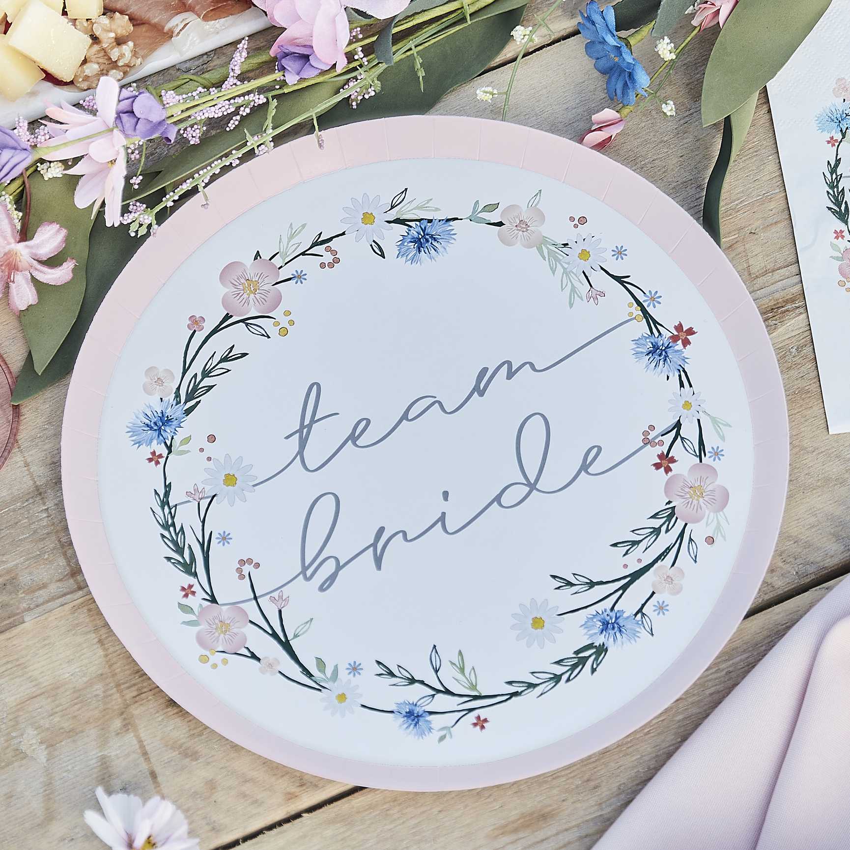 floral flower design paper party plates with the words 'team bride' written on them for a boho or garden party theme bachelorette, bridal shower or hens party