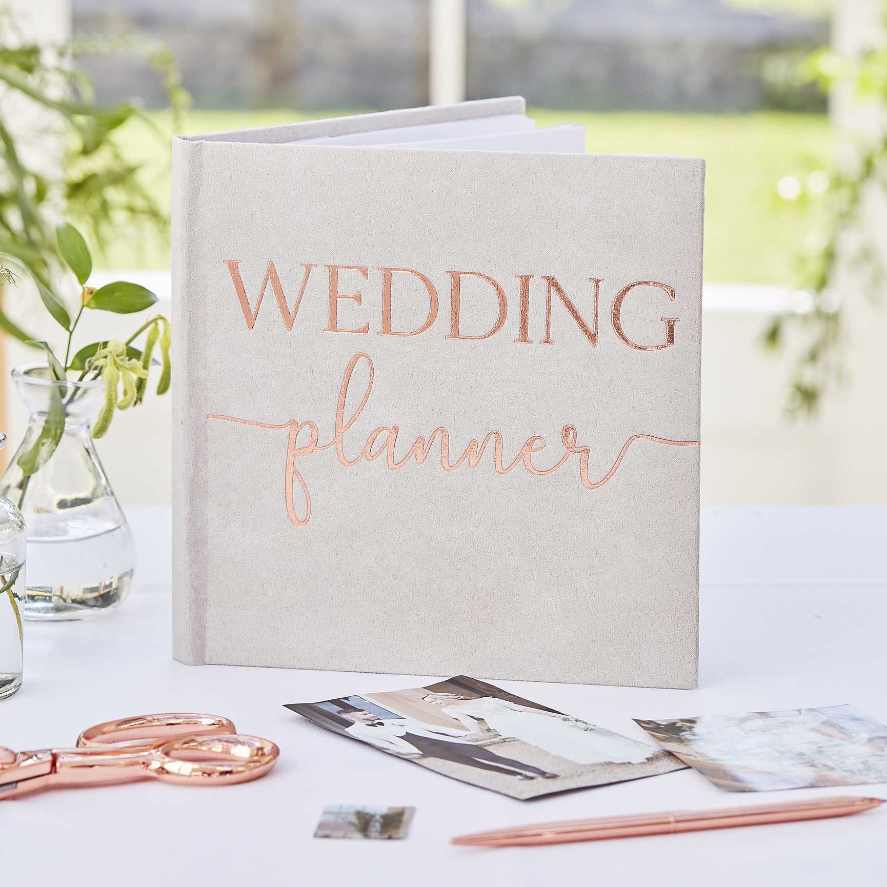 grey suede wedding planner journal book with the words 'wedding planner' printed on the front in rose gold for an engagement party or bridal shower, hens party gift