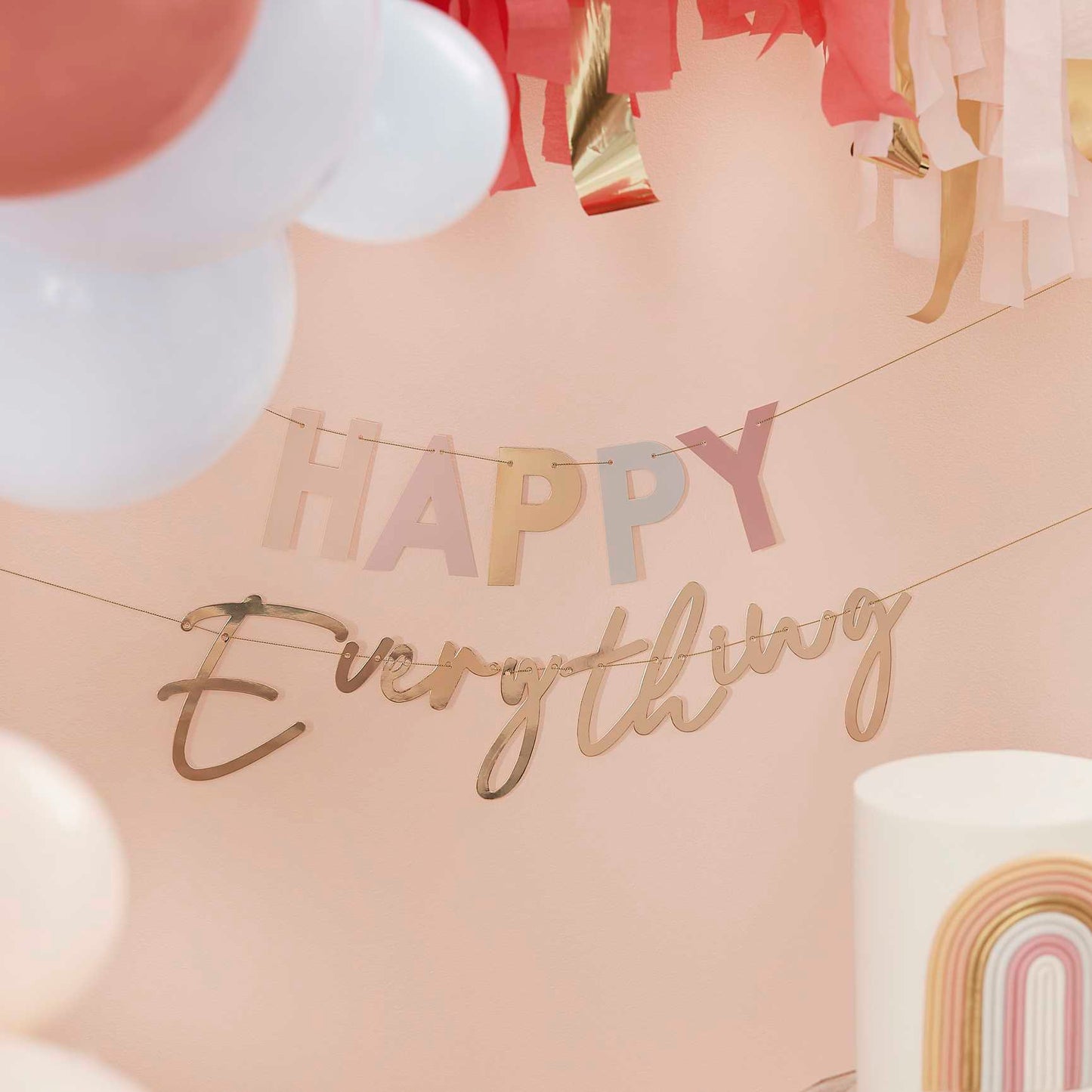 pastel nude coloured hanging banner bunting that says the words 'happy everything' for a birthday party decoration