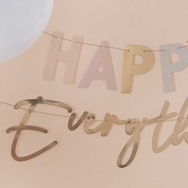 pastel nude coloured hanging banner bunting that says the words 'happy everything' for a birthday party decoration