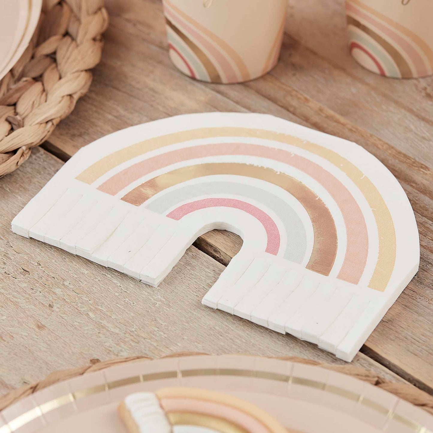 muted pastel neutral themed paper party napkins that are in the shape of a rainbow featuring muted pastel earthy tones for a happy joyful birthday party theme