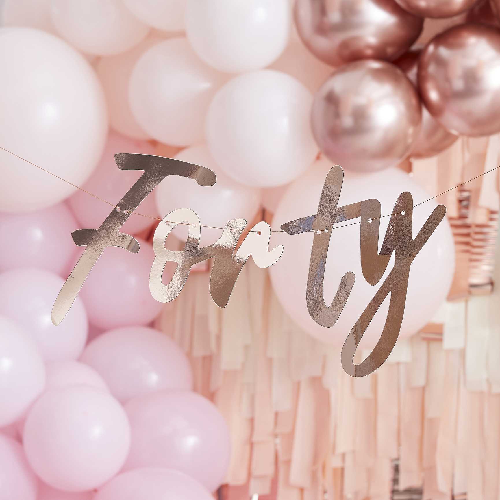 Rose gold wording banner that says 'forty' for a 40th birthday party decoration