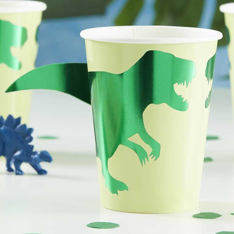 green dinosaur paper party cups with a 3d pop out dinosaur tail for a kids dinosaur birthday party theme decoration