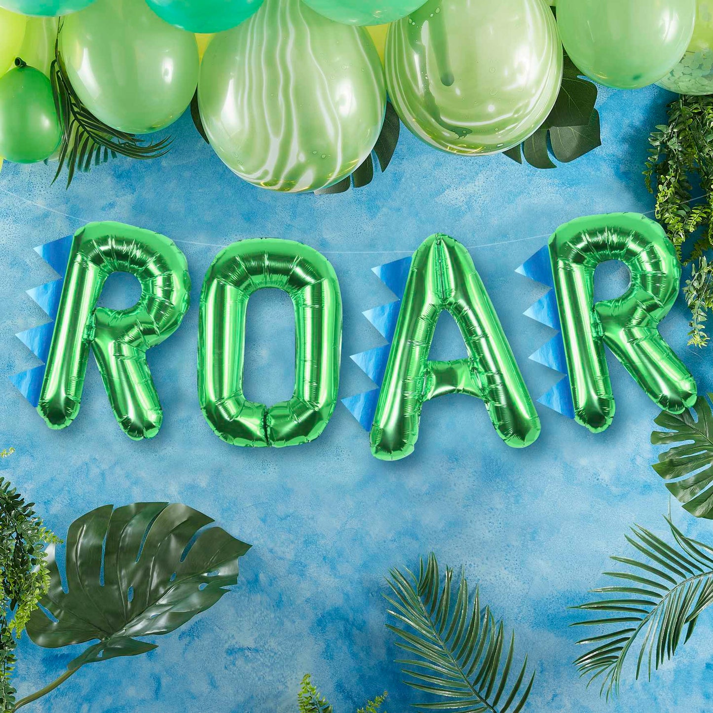 Green foil balloons that read the words "ROAR' for a kids dinosaur birthday party theme decoration