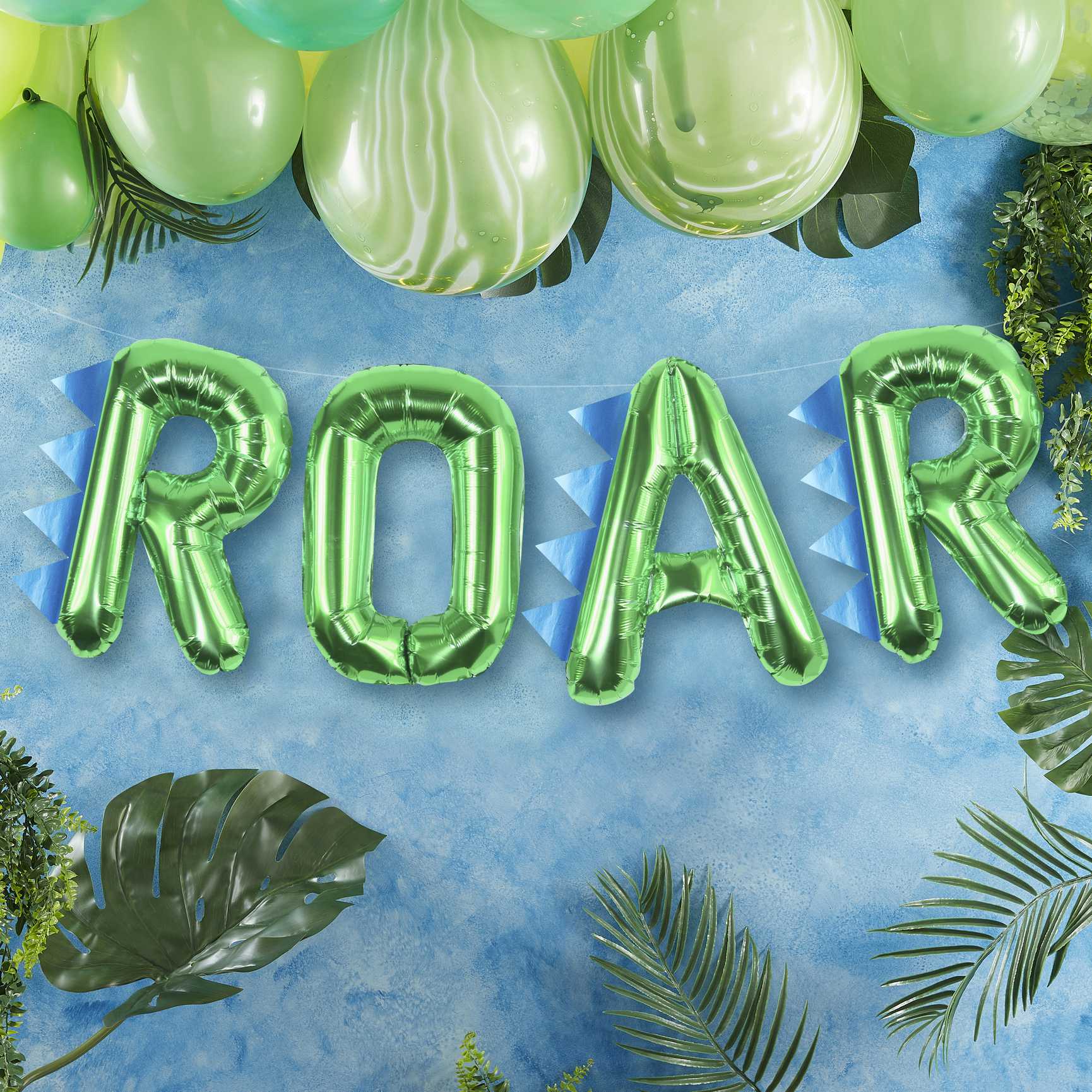 Green foil balloons that read the words "ROAR' for a kids dinosaur birthday party theme decoration