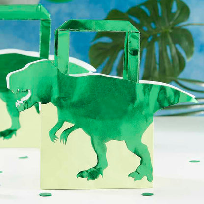 green dinosaur paper party bags with a 3d dinosaur design for a kids dinosaur party theme treat or gift bags