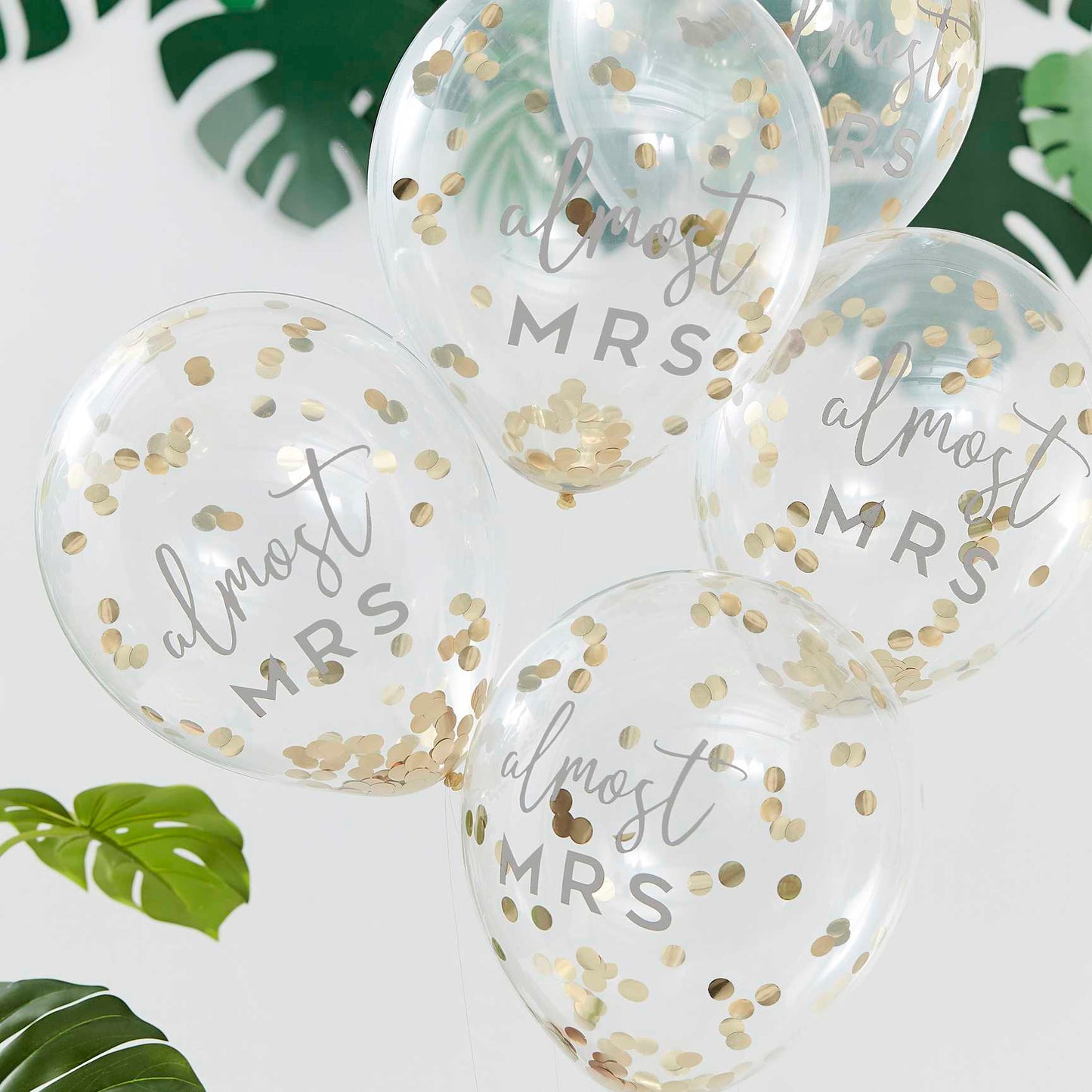 clear balloons fileed with gold confetti with the writing 'almost mrs' written on them for bridal showers, hens party or bachelorette gold theme party decorations