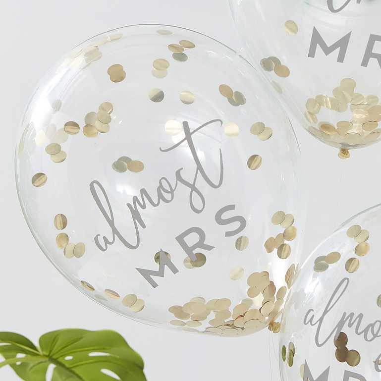 clear balloons fileed with gold confetti with the writing 'almost mrs' written on them for bridal showers, hens party or bachelorette gold theme party decorations