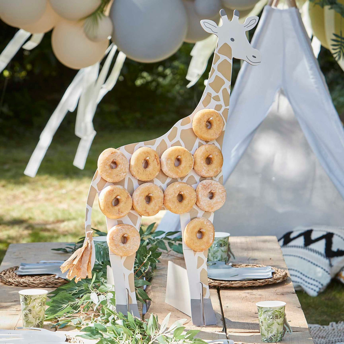 Giraffe shaped doughbnut display stand for a wild animal jungle safari theme birthday party for kids