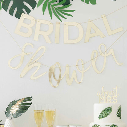 gold bridal shower hanging banner butning with the words 'bridal shower' for a bridal shower gold theme party decoration