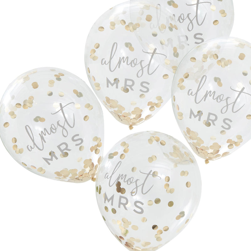 clear balloons fileed with gold confetti with the writing 'almost mrs' written on them for bridal showers, hens party or bachelorette gold theme party decorations