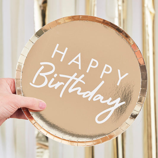 gold paper party plates with the words 'happy birthday' printed on them in white for a gold theme birthday party decoration