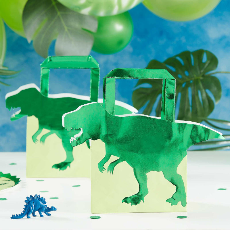 green dinosaur paper party bags with a 3d dinosaur design for a kids dinosaur party theme treat or gift bags