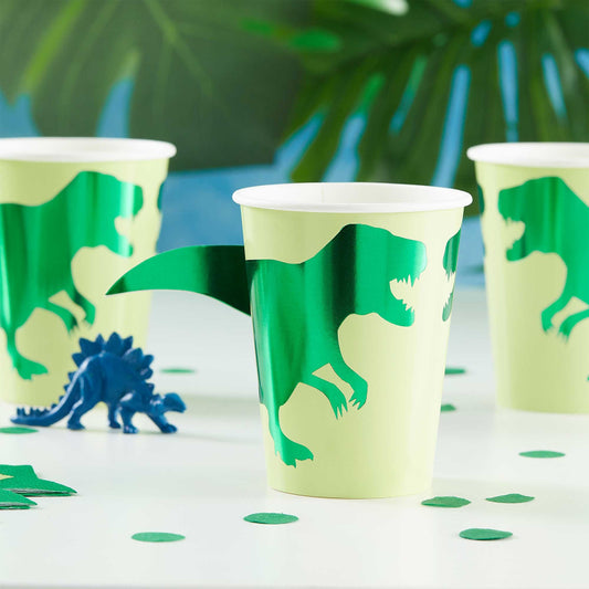 green dinosaur paper party cups with a 3d pop out dinosaur tail for a kids dinosaur birthday party theme decoration