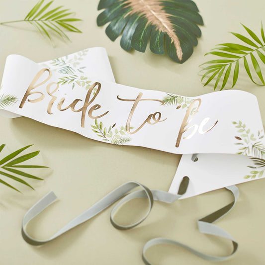 botanical design hens party sash with the words 'bride to be' printed on it in gold for a bridal shower, hens party or bachelorette party gift